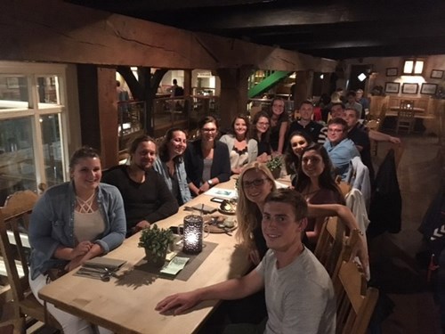 Group of people at a long table in a restaurant