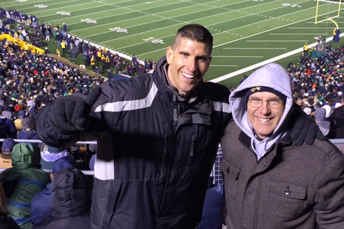 Andrew Lenhardt (left) with his father watching Notre Dame play 
USC.