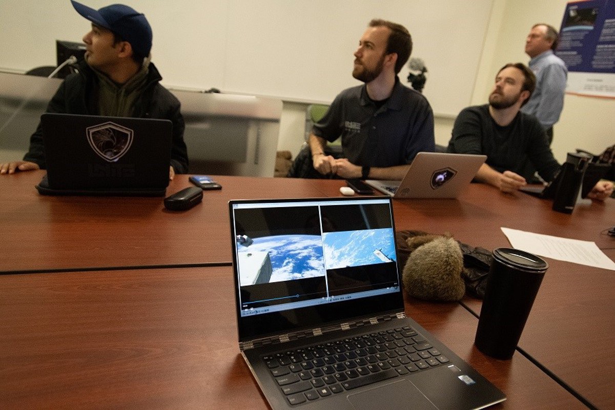 UNITE undergraduate team members watch as the CubeSat they helped build is launched and deployed from the International Space Station. 