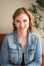 woman sitting on a couch wearing a faded jean jacket