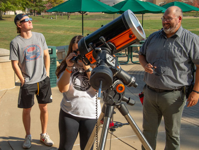 Students using a telescope.