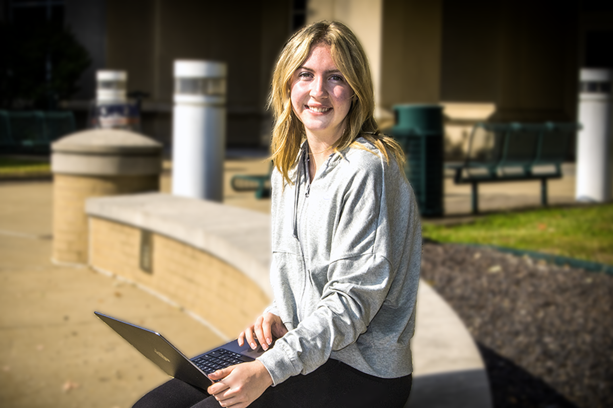 Keira Moore '26 sitting outside of the Liberal Arts Center.