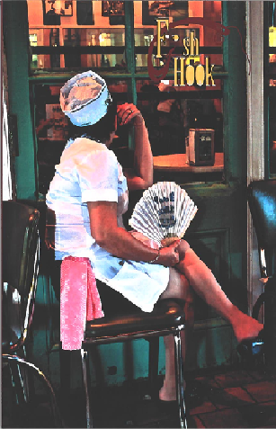 A waitress taking a break sitting outside while looking into a restaurant