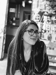 Amie Whittemore standing by a pond in the woods