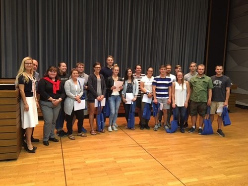 Group of people holding graduation certificates