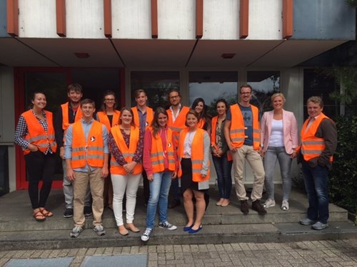 Group of people wearing orange safety vests